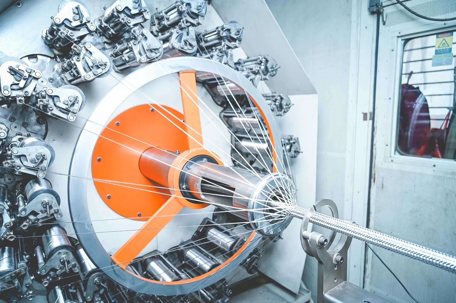 Stainless steel hose braiding machine on the Vigyan production floor